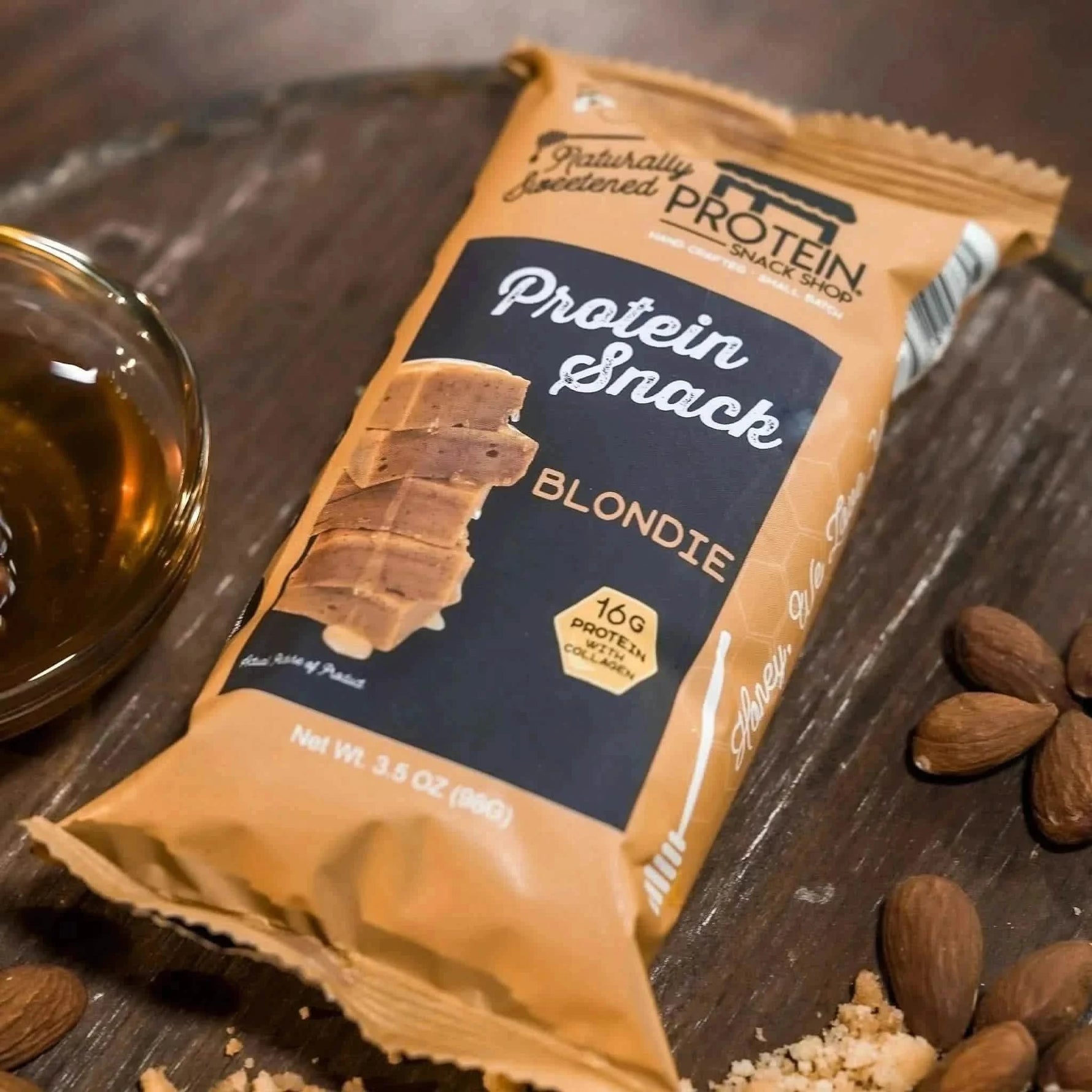 Top view package of gourmet honey-sweetened blondie protein snack, 5-count, gluten-free and high-protein.