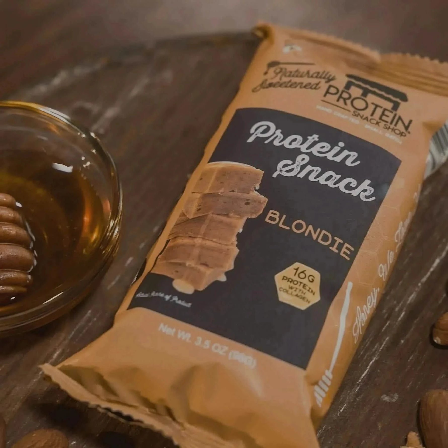 Top view package fourth of gourmet honey-sweetened blondie protein snack, 5-count, gluten-free and high-protein.