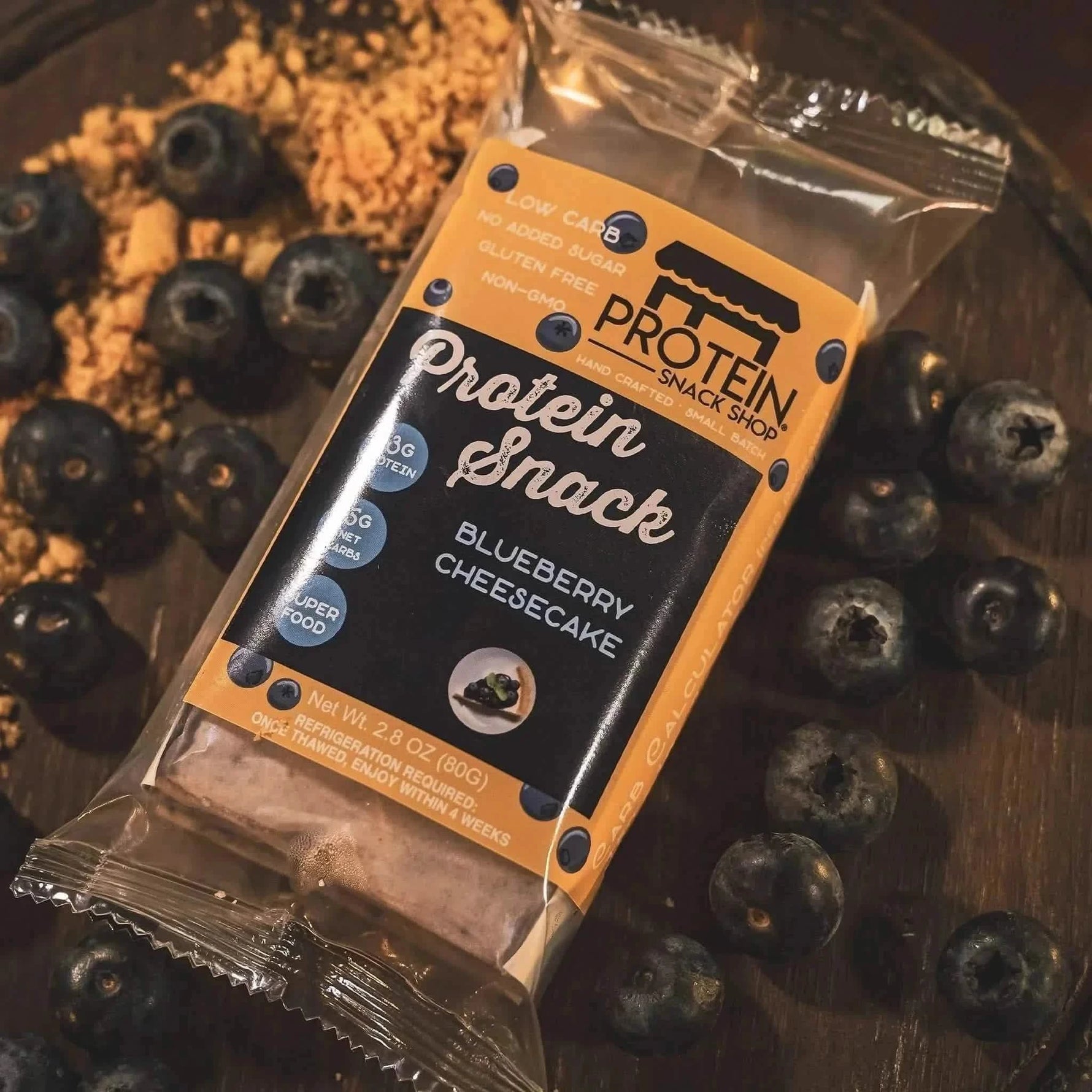 Top view package of blueberry cheesecake protein snack, 5-count, gluten-free and keto-friendly.