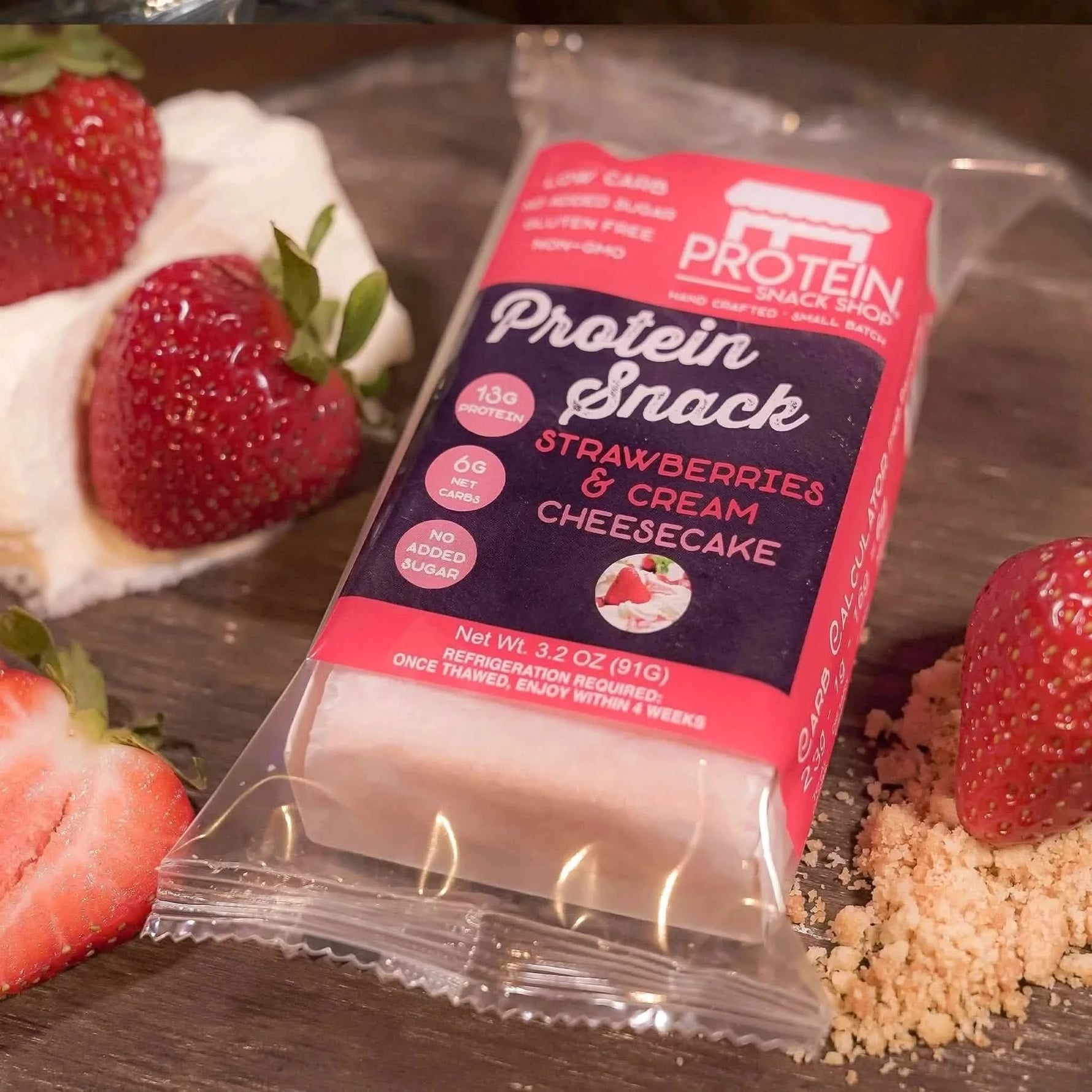 Top view package third of strawberries and cream cheesecake protein snack, 5-count, gluten-free and keto-friendly.